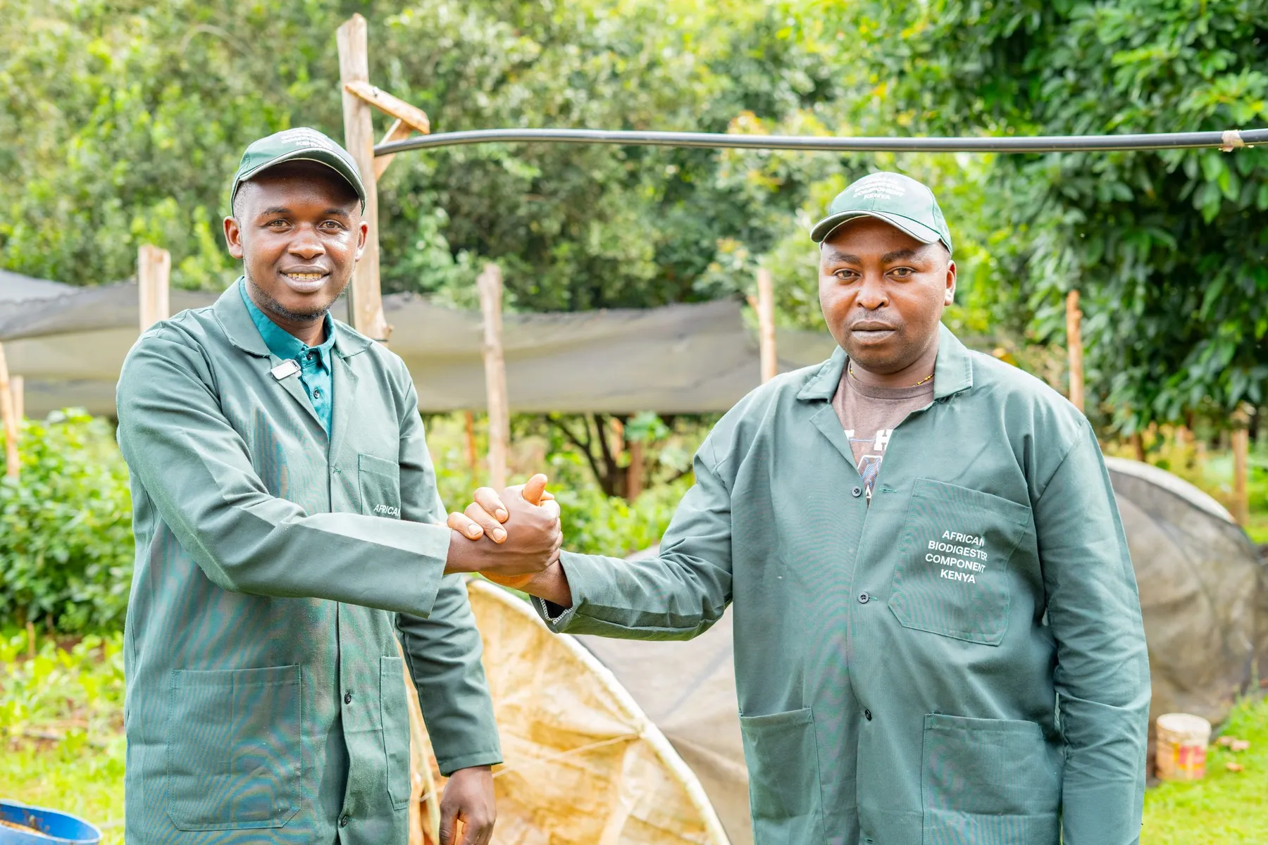 Two farmers shaking hands at a demonstration farm